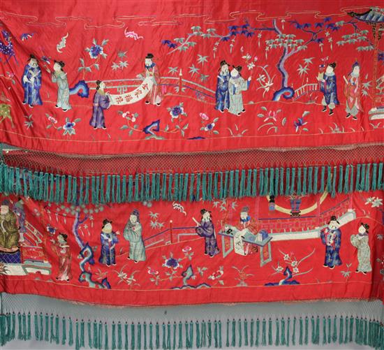 A Chinese embroidered silk red satin panel, early 20th century, approx. 66 x 410cm.